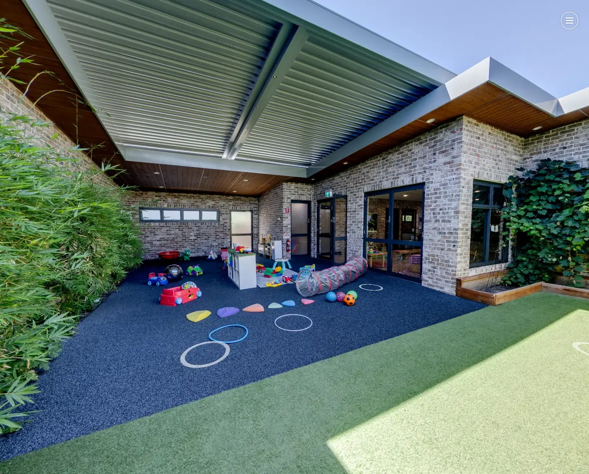 Sheltered outdoor garden play area for Nido infants at Little Blossoms Academy