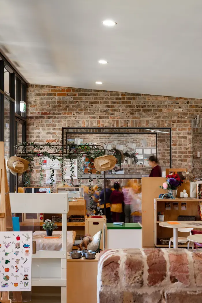 Bright, airy playroom with recycled brick walls and natural light at Little Blossoms Academy